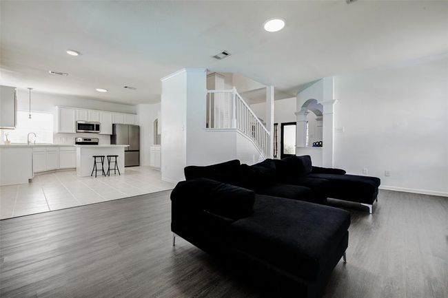 The spacious living room offers brand new vinyl flooring and wood burning fireplace | Image 7