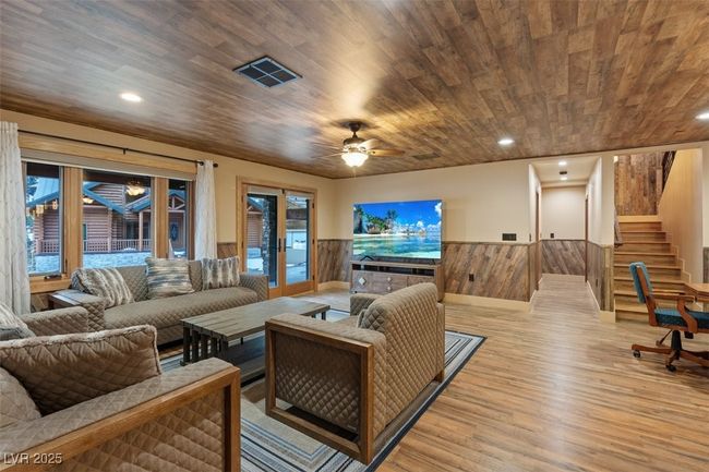 Living area featuring visible vents, wainscoting, wood finished floors, and wood ceiling | Image 44