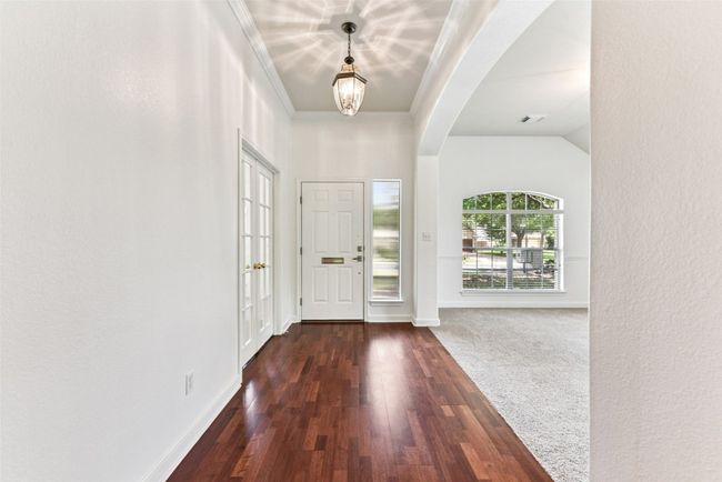 Foyer entrance with high ceilings, crown molding and open to the front living room | Image 4