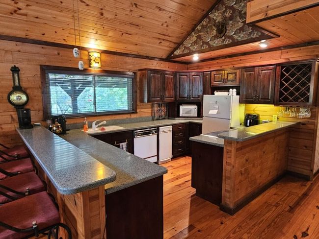 This Beautiful Home features a Gorgeous Kitchen with Bar Countertops open to the Living Area! | Image 9