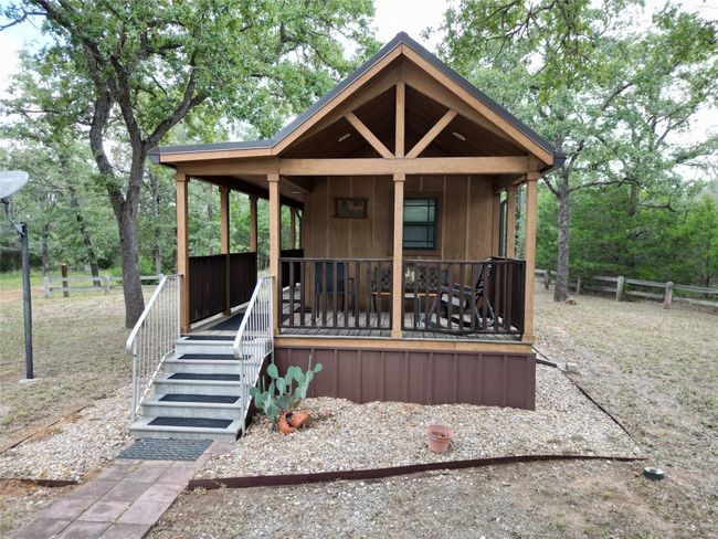Rustic home featuring a porch | Image 11