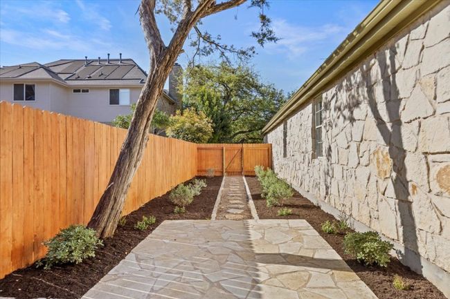 Pavers form a pathway from the side gate to the backyard, enhanced by simple yet stylish landscaping. | Image 31