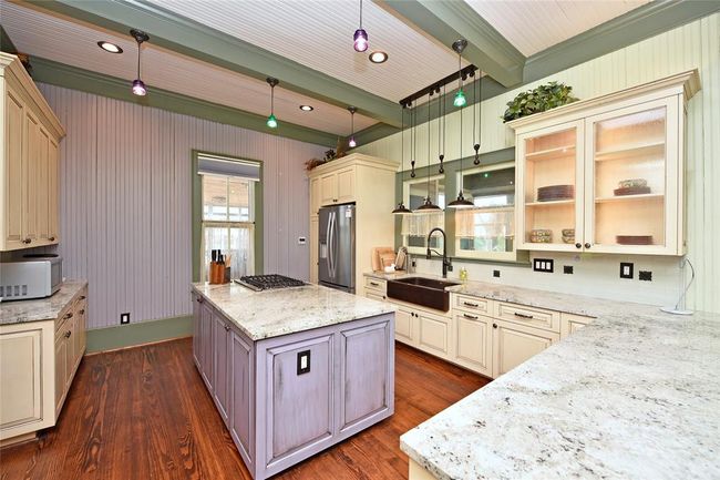 The kitchen in the main house. Granite counters, custom cabinets, apron sink, adorable lighting and comes with all you need to cook a complete meal. | Image 12