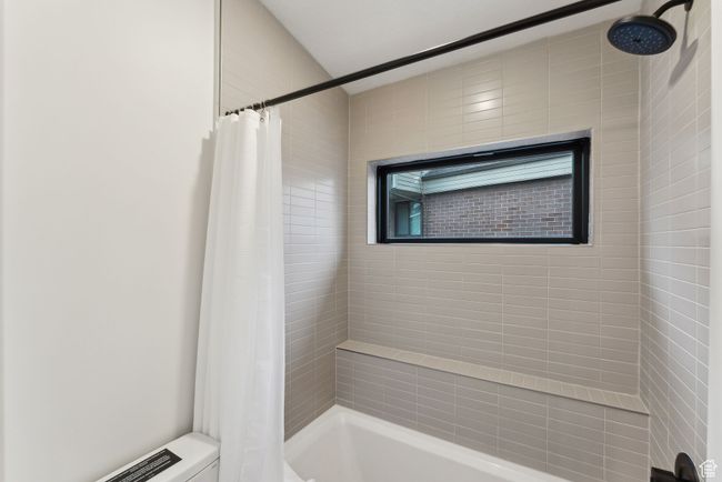 Bathroom featuring shower / bath combination with curtain | Image 31