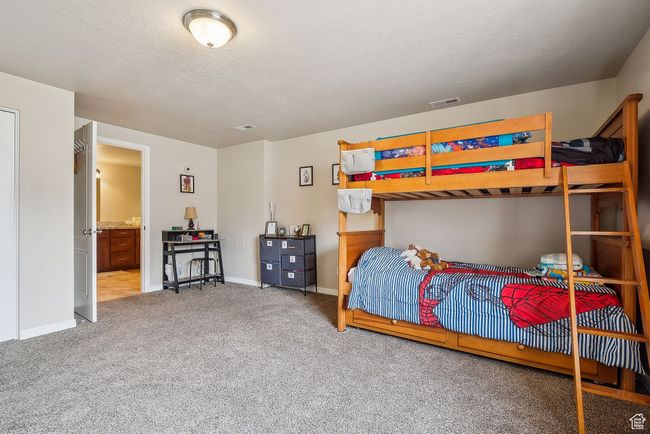 Bedroom with carpet, visible vents, and baseboards | Image 49