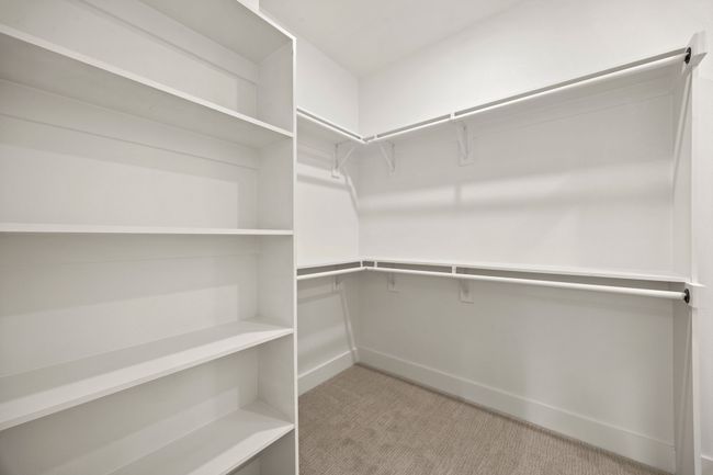 Spacious closet with light carpet | Image 20