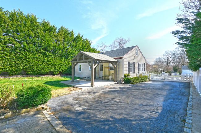 View of property exterior featuring a gazebo, fence, and a patio area | Image 19