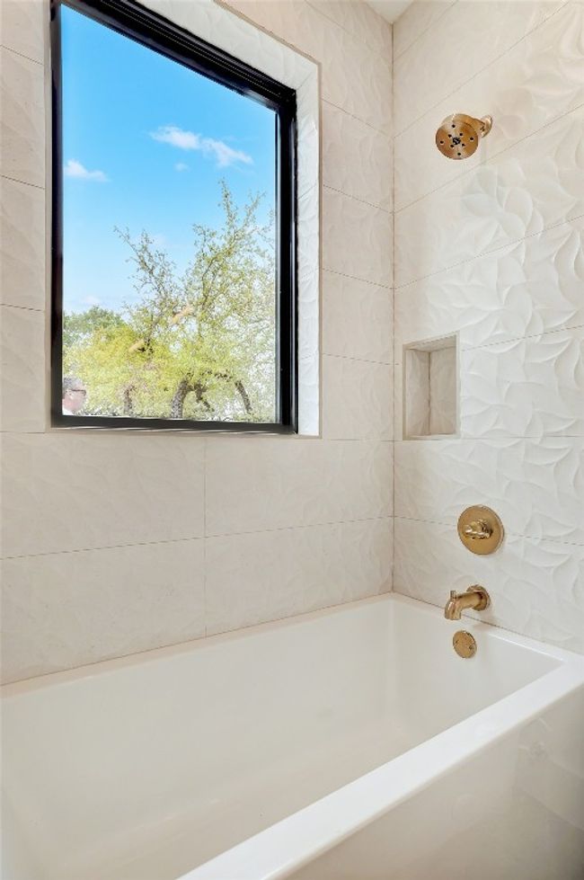 Full bathroom with plenty of natural light and a tub to relax in | Image 19