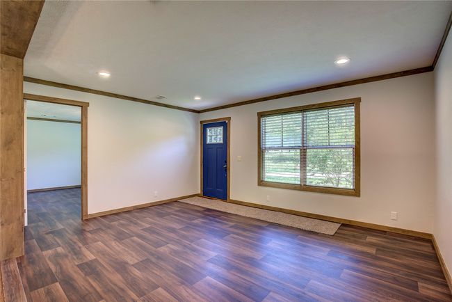Empty room featuring crown molding, dark wood-style flooring, and recessed lighting | Image 8