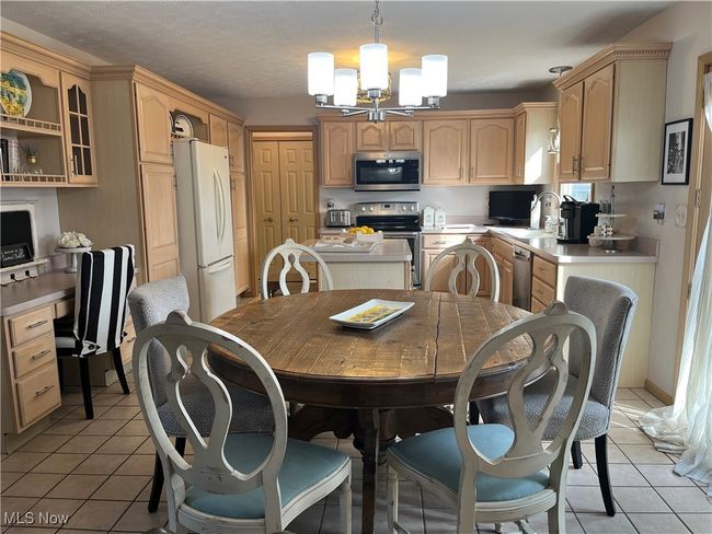 Large, functional Kitchen with lots of cabinet space, double pantry and Island. | Image 6