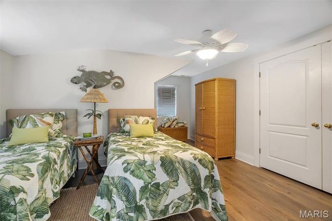 Bedroom featuring light wood-style flooring and a ceiling fan | Image 73