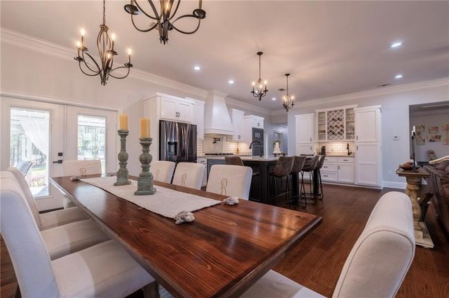Dining room featuring sink, dark hardwood / wood-style flooring, crown molding, and french doors | Image 13