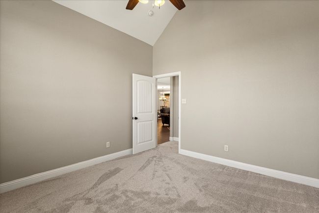 Unfurnished room featuring a ceiling fan, light colored carpet, and high vaulted ceiling | Image 8