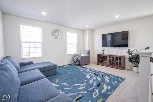 living area with baseboards, recessed lighting, carpet, and a textured ceiling | Image 25