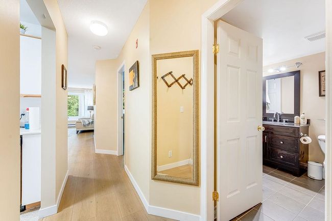 Corridor featuring a sink, baseboards, and light wood-type flooring | Image 22