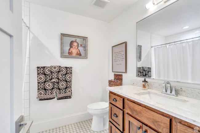 Bathroom with vanity and a shower with curtain | Image 49