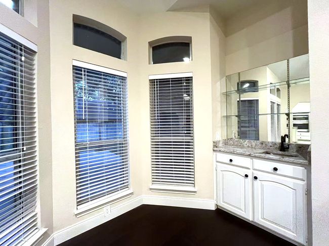 Bar area with a sink and dark wood-style flooring | Image 13