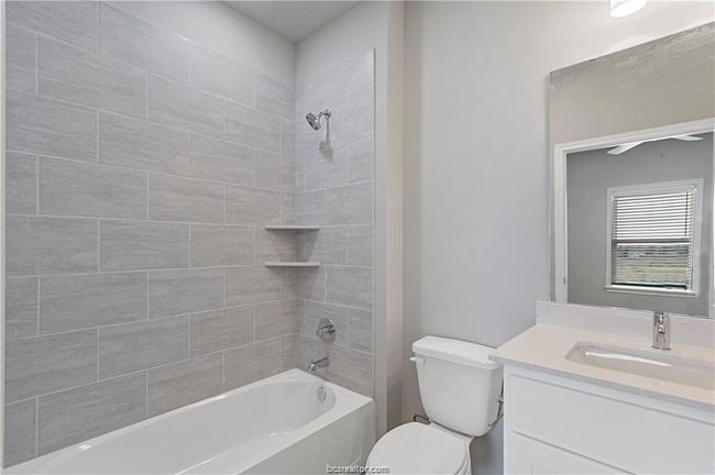 Full bathroom with toilet, tiled shower / bath, and vanity | Image 17
