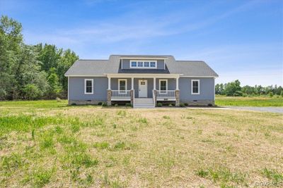 View of front of property featuring a front lawn and a porch | Image 1