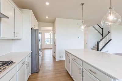 (Photo of a decorated model, actual finishes will vary) The center island extends out to a breakfast bar for casual meals | Image 2