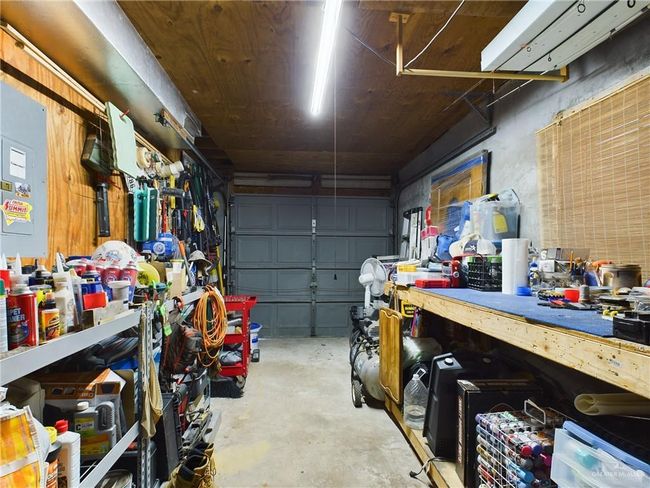 Garage with a workshop area | Image 16