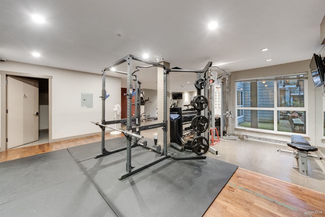 Workout room featuring light wood-style floors, recessed lighting, and electric panel | Image 19