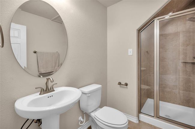 Inviting downstairs guest bathroom with a convenient shower. | Image 18