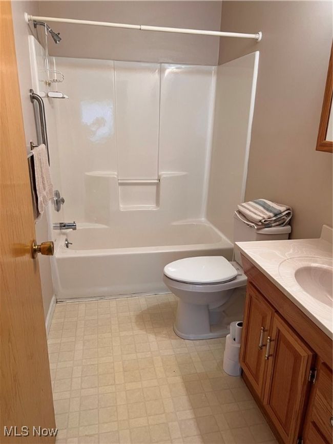 Full bath featuring vanity, tile patterned floors, and shower / washtub combination | Image 9