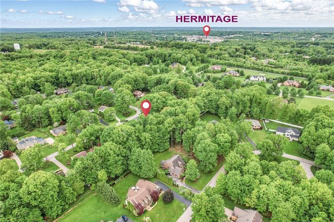 Aerial view of a lovely home nestled amongst mature trees. | Image 49