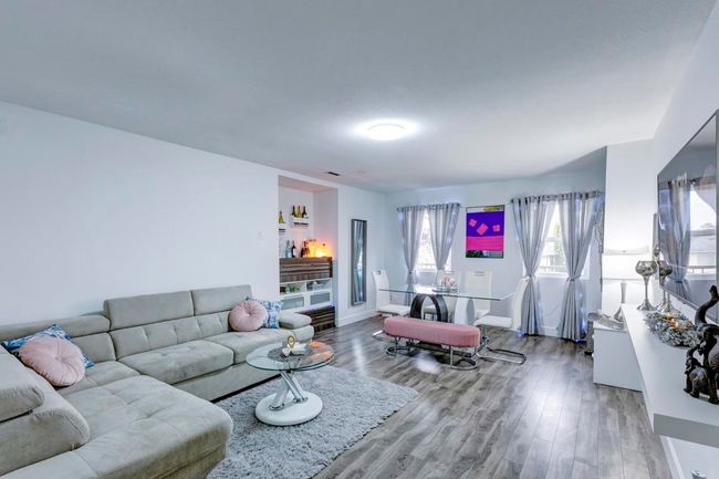 Living area featuring baseboards and wood finished floors | Image 26