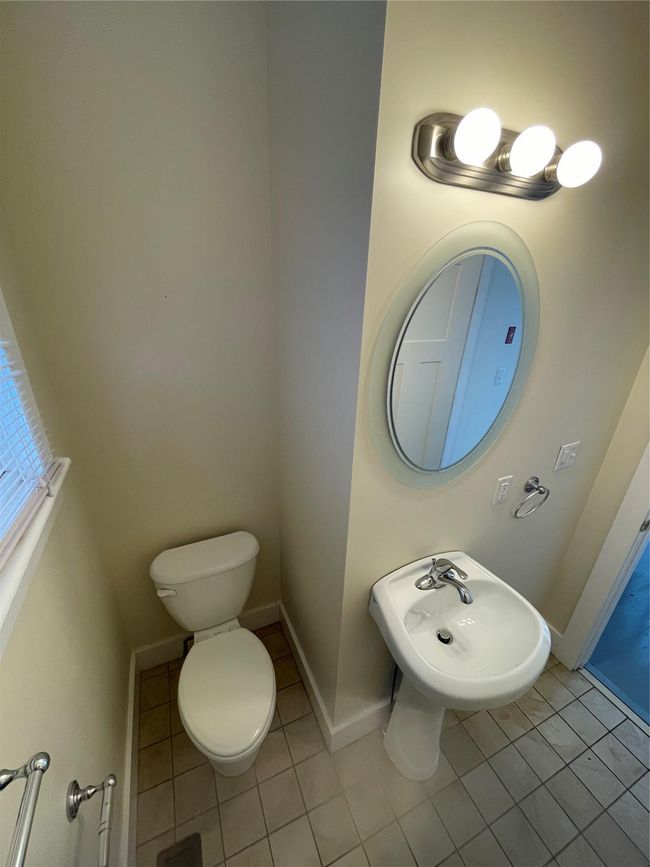 Bathroom featuring tile patterned flooring, toilet, and baseboards | Image 12