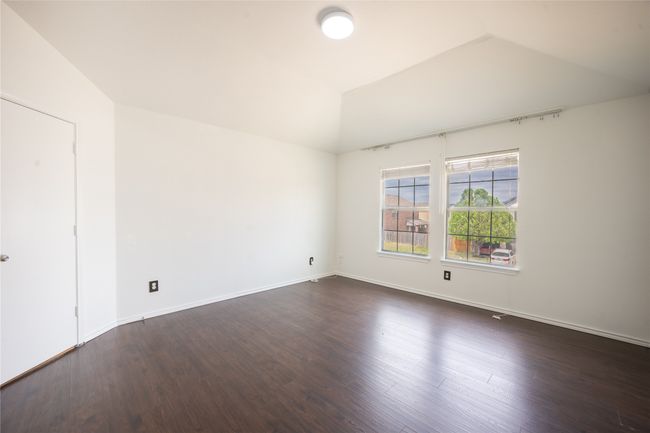 Unfurnished room with baseboards, vaulted ceiling, and dark wood finished floors | Image 7
