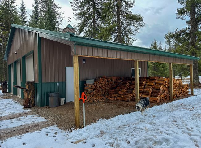 Snow covered structure featuring an outdoor structure and a pole building | Image 5