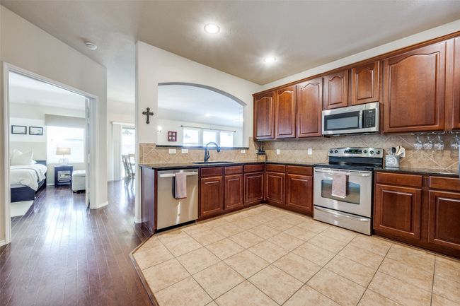 Kitchen featuring stainless steel appliances, arched walkways, backsplash, recessed lighting | Image 14