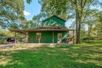 Experience peaceful country living in this charming home at 9365 Crystal Springs Drive nestled among lush greenery! Surrounded by a beautiful garden and a vast lawn, this cozy home offers a serene escape under the clear blue skies. | Image 1