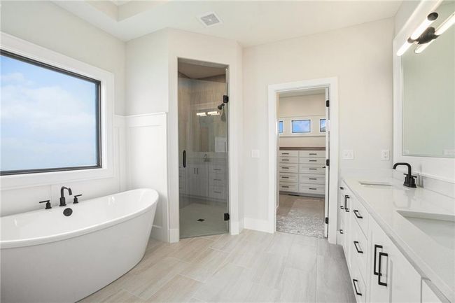 Full bath with a shower stall, double vanity, a soaking tub, and a spacious closet | Image 19
