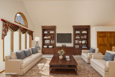 Gorgeous main floor sun room flows from the formal dining room to the eat in dining off the kitchen. This room walks out to the expansive maintenance free east deck | Image 3