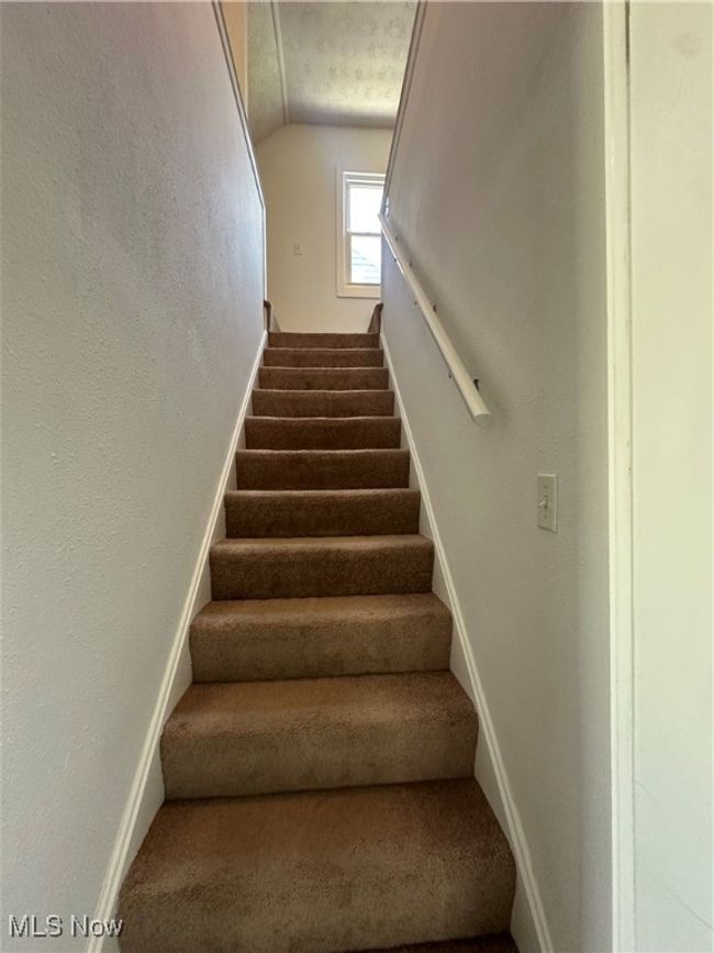 Stairway featuring baseboards and vaulted ceiling | Image 26