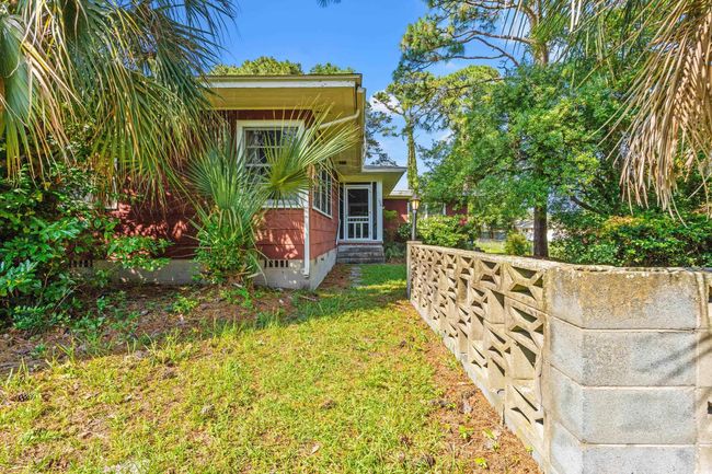 View of side of home featuring entry steps, a yard, and crawl space | Image 27