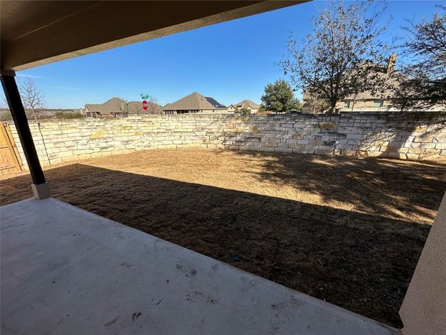 View of yard featuring a fenced backyard and a patio area | Image 27