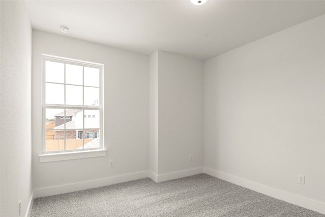 Empty room with a healthy amount of sunlight, baseboards, and carpet flooring | Image 26