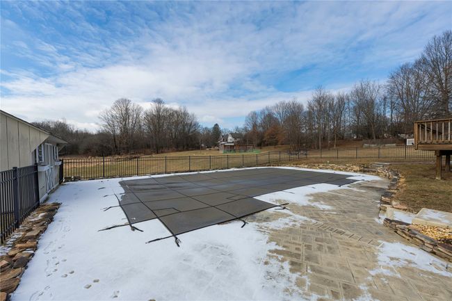 View of swimming pool with a deck and a patio area | Image 34