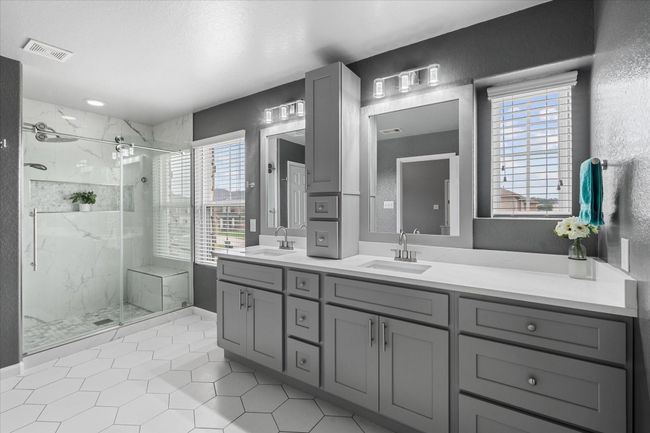 Primary bathroom updated recently! Features include beautiful tiled frameless glass shower and his/hers undermount sinks with gorgeous quarzt countertop | Image 21