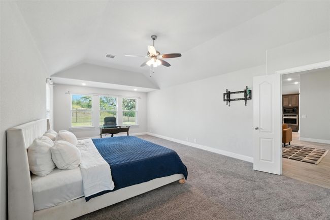 Bedroom featuring lofted ceiling, ceiling fan, light colored carpet, and recessed lighting | Image 20