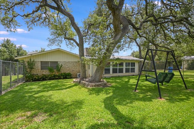 Looking at the back of the home. The dog run can make a great play yard for young kids. | Image 34