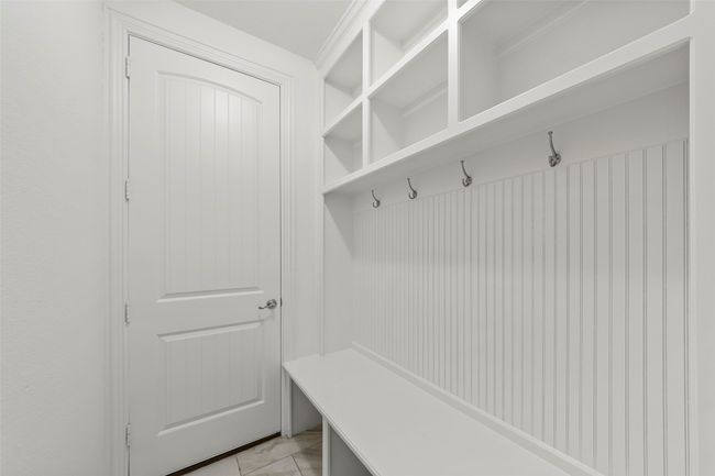 Mudroom with light tile patterned floors | Image 39