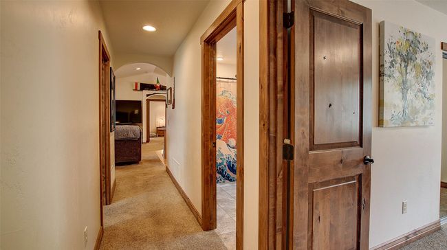 Corridor featuring arched walkways, light carpet, recessed lighting, and baseboards | Image 29