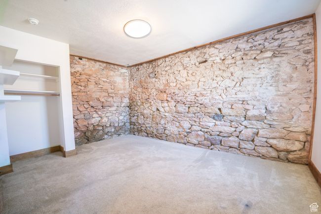 Carpeted spare room featuring crown molding, a textured ceiling, and baseboards | Image 13