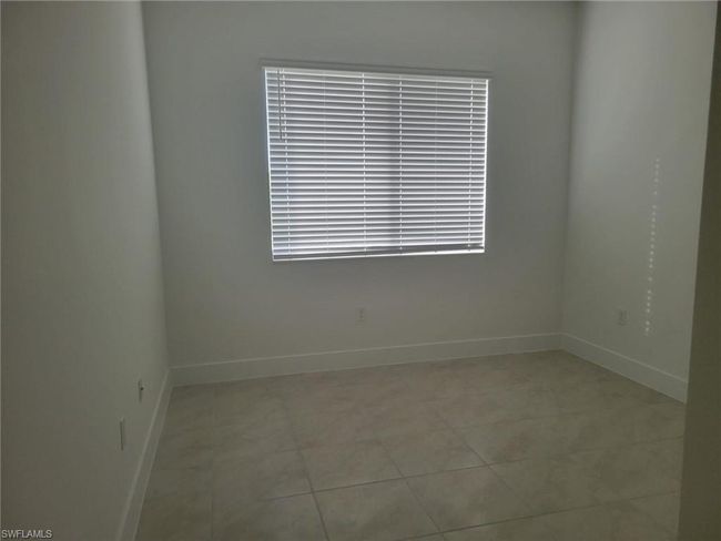 Unfurnished room featuring baseboards and light tile patterned floors | Image 18