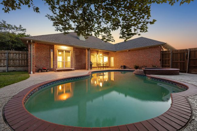 View of swimming pool with a patio and a fenced backyard | Image 33